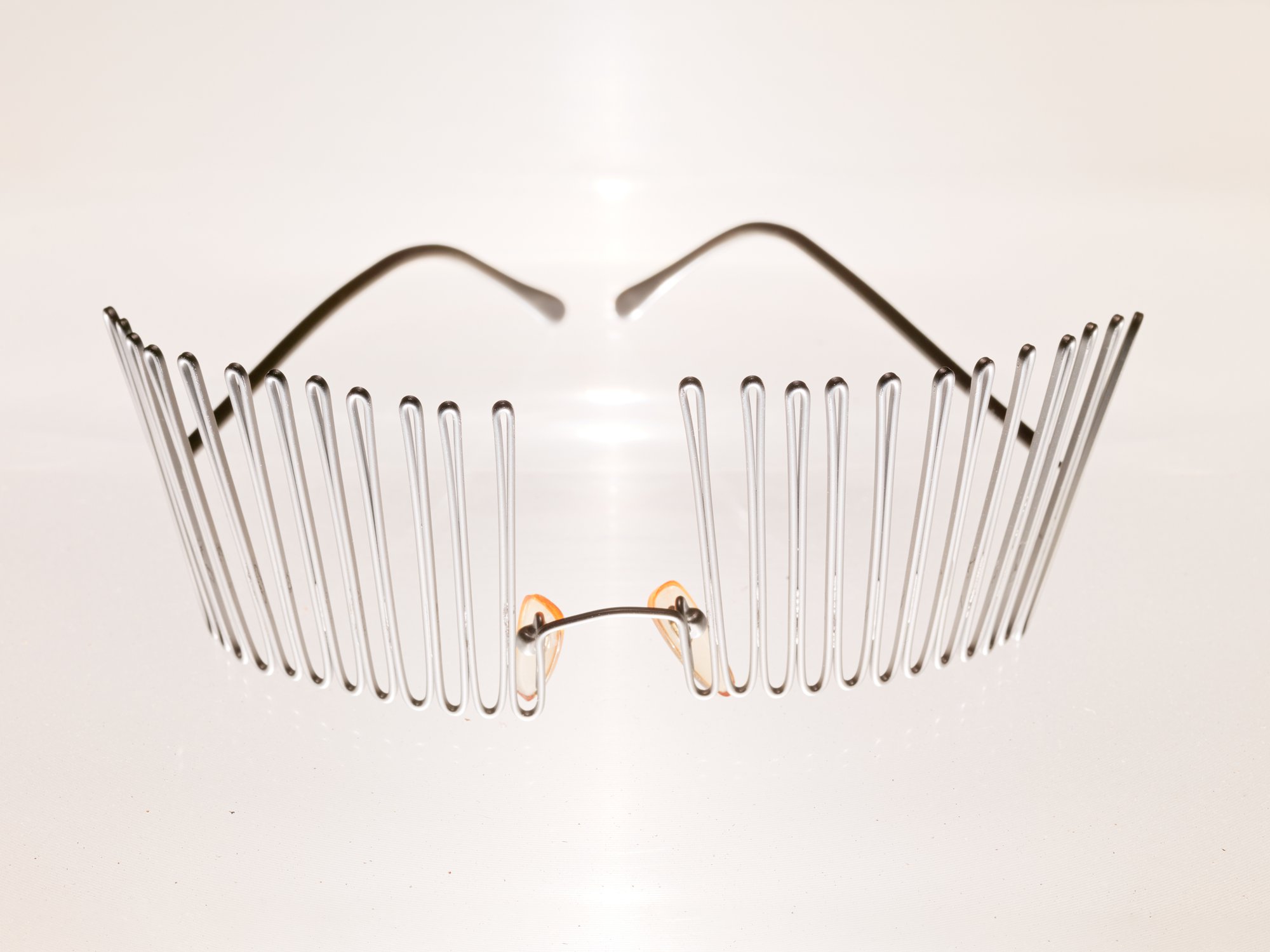 Issey Miyake glasses presentation specially conceived together with Haris Epaminonda, glasses, aluminum plinth, overhead projector